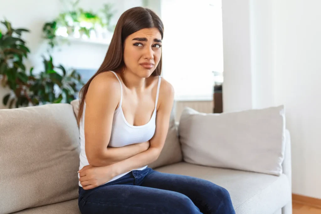 woman-painful-expression-holding-hands-against-belly-suffering-menstrual-period-pain-lying-sad-home-bed-having-tummy-cramp-female-health-concept