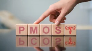 Wooden blocks spelling PMOS replacing PCOS, symbolizing the renaming of the condition to Polyendocrine Metabolic Ovarian Syndrome