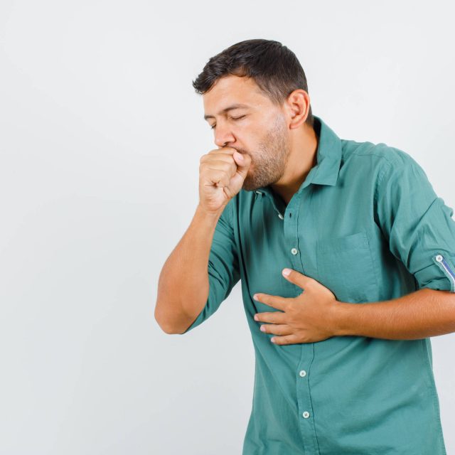 young-man-suffering-from-cough-shirt-looking-ill-scaled.jpg